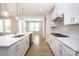 Beautiful kitchen featuring white cabinets, stainless steel appliances, and a large kitchen island at 256 W Waterlynn Rd, Mooresville, NC 28117