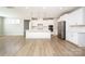Modern kitchen featuring stainless steel appliances, island with pendant lighting, and white cabinetry at 256 W Waterlynn Rd, Mooresville, NC 28117