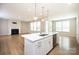 Modern kitchen featuring an island, stainless steel appliances, and an open concept living space at 256 W Waterlynn Rd, Mooresville, NC 28117