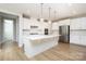 Bright kitchen featuring stainless appliances, center island, and ample cabinet space for storage at 256 W Waterlynn Rd, Mooresville, NC 28117