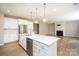 Bright open kitchen features a large island, stainless steel appliances, and access to the living room at 256 W Waterlynn Rd, Mooresville, NC 28117