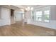 Bright living room features wood floors, crown molding, and large windows at 256 W Waterlynn Rd, Mooresville, NC 28117