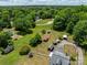 Aerial view of a property with multiple storage sheds, carports, white fence, and a detached gazebo at 2809 N Main St, Kannapolis, NC 28081