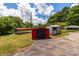 Property featuring multiple storage sheds and carports in the expansive backyard with a concrete pad at 2809 N Main St, Kannapolis, NC 28081