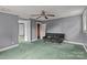 An interior bedroom showing the ceiling fan, and walls painted in shades of gray and green carpet at 2809 N Main St, Kannapolis, NC 28081