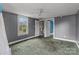 A bedroom with a window overlooking green trees, complemented by gray walls and a ceiling fan at 2809 N Main St, Kannapolis, NC 28081