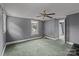 A bedroom with a window overlooking green trees, complemented by gray walls and a ceiling fan at 2809 N Main St, Kannapolis, NC 28081