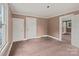 A bedroom with windows and bare walls and flooring and a closet at 2809 N Main St, Kannapolis, NC 28081