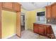 The kitchen shows wood cabinets with yellow walls and a light tile floor at 2809 N Main St, Kannapolis, NC 28081