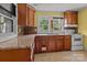 A kitchen featuring wood cabinets, a countertop, a sink, and a white stove at 2809 N Main St, Kannapolis, NC 28081