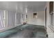 An empty sunroom with white paneled walls, a fan, and multiple windows at 2809 N Main St, Kannapolis, NC 28081