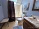 Standard bathroom with a combined tub and shower, neutral-toned walls, and patterned flooring at 2815 Penny Park Dr, Gastonia, NC 28052