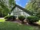Exterior side view of a green home featuring neat shrubbery and well-kept lawn at 2815 Penny Park Dr, Gastonia, NC 28052