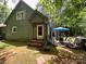 Charming green home exterior with a welcoming front porch and an inviting outdoor patio area at 2815 Penny Park Dr, Gastonia, NC 28052