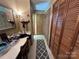 Hallway with vanity area, natural wood cabinets, and tile floor at 2815 Penny Park Dr, Gastonia, NC 28052