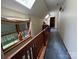 Hallway with carpeted floors and multiple skylights over a wooden railing at 2815 Penny Park Dr, Gastonia, NC 28052
