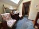 Cozy living room showcasing floral chairs, a skylight, and classic wooden furniture details at 2815 Penny Park Dr, Gastonia, NC 28052