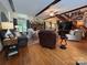 Comfortable living room with hardwood floors, a brick fireplace, dark wood beams, and plenty of seating at 2815 Penny Park Dr, Gastonia, NC 28052