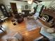 Bright living room boasts hardwood floors, a brick fireplace, and lots of comfortable seating for entertaining at 2815 Penny Park Dr, Gastonia, NC 28052
