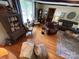 Bright living room featuring hardwood floors, a gray sofa, brick fireplace, and carefully chosen decor at 2815 Penny Park Dr, Gastonia, NC 28052