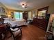 This main bedroom features hardwood floors, a ceiling fan and plentiful natural light at 2815 Penny Park Dr, Gastonia, NC 28052
