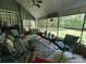 Cozy screened porch furnished with comfortable seating and views of the outdoor greenery at 2815 Penny Park Dr, Gastonia, NC 28052