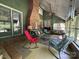 Relaxing screened porch features a brick fireplace and vaulted ceilings, perfect for outdoor lounging at 2815 Penny Park Dr, Gastonia, NC 28052