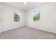 Neutral bedroom with carpeted floors, and two large windows, perfect for creating a relaxing retreat at 3121 Revolution Park Dr, Charlotte, NC 28217