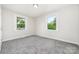 Inviting bedroom with neutral carpet and paint and two large windows allowing plenty of natural light at 3121 Revolution Park Dr, Charlotte, NC 28217