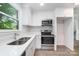 Modern kitchen features stainless appliances, stylish white cabinetry and double sink with a window view at 3121 Revolution Park Dr, Charlotte, NC 28217