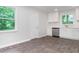 Bright kitchen featuring modern gray flooring, stainless steel appliances, and freshly painted white walls at 3121 Revolution Park Dr, Charlotte, NC 28217