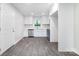 Modern kitchen with stainless steel appliances, including a built-in microwave and gray wood-look tile flooring at 3121 Revolution Park Dr, Charlotte, NC 28217