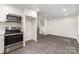 Modern kitchen with stainless steel appliances, including a built-in microwave and gray wood-look tile flooring at 3121 Revolution Park Dr, Charlotte, NC 28217
