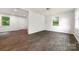 Bright living room with natural light, featuring modern gray flooring and freshly painted neutral walls at 3121 Revolution Park Dr, Charlotte, NC 28217