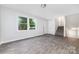 Bright living room with natural light, featuring modern gray flooring, stairs, and freshly painted neutral walls at 3121 Revolution Park Dr, Charlotte, NC 28217