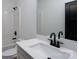 Modern bathroom features white vanity with black hardware, toilet, and tiled shower at 315 W Hoke W St, Landis, NC 28088