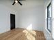 Minimalist bedroom featuring wood-look flooring, neutral walls, and one bright window at 315 W Hoke W St, Landis, NC 28088
