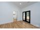 Bedroom with hardwood floors, double glass doors, and white trim at 315 W Hoke W St, Landis, NC 28088
