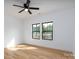 Spacious bedroom features wood-look flooring, modern ceiling fan, and large windows at 315 W Hoke W St, Landis, NC 28088