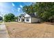 Charming new construction home with white siding and black trim, nestled among mature trees at 315 W Hoke W St, Landis, NC 28088
