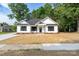 Charming new construction features a modern farmhouse exterior with manicured lawn at 315 W Hoke W St, Landis, NC 28088