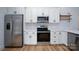 Modern kitchen with stainless steel appliances, white cabinets, subway tile backsplash, and ample counter space at 315 W Hoke W St, Landis, NC 28088
