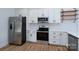 Bright kitchen features stainless steel appliances and white cabinets at 315 W Hoke W St, Landis, NC 28088