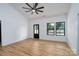 Bright living room with black-trimmed windows, a ceiling fan, and wood floors at 315 W Hoke W St, Landis, NC 28088