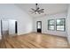 Bright living room with black-trimmed windows, a ceiling fan, and hardwood floors at 315 W Hoke W St, Landis, NC 28088