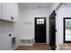 Well-organized mud room with coat hooks, bench seating, storage, and easy access to laundry at 315 W Hoke W St, Landis, NC 28088