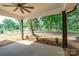 Covered patio offers outdoor living space with ceiling fan and views of the wooded backyard at 315 W Hoke W St, Landis, NC 28088