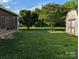 Expansive backyard featuring lush green grass and mature trees, creating a serene outdoor space at 319 Glenhaven Dr, Charlotte, NC 28214