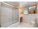 Bathroom featuring shower-tub combo, mirror, window and toilet at 319 Glenhaven Dr, Charlotte, NC 28214