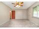 Carpeted bedroom with doors and a window allowing natural light at 319 Glenhaven Dr, Charlotte, NC 28214